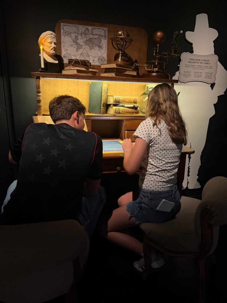 Visitors at the Professor's desk exhibit inside QUAKE
